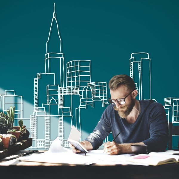 Caucasian man working with building illustration on green background