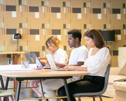 creative-team-sitting-together-table-with-blueprints-working-project_74855-9771