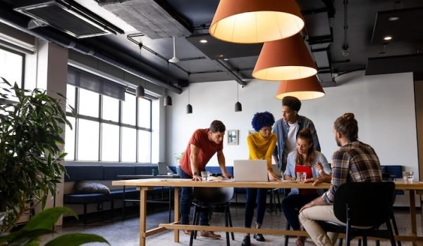diverse-male-female-colleagues-discussion-using-laptop-tablet-casual-office-meeting-casual-office-communication-teamwork-business-creative-work-unaltered_13339-338558