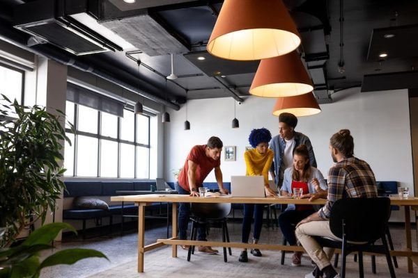 diverse-male-female-colleagues-discussion-using-laptop-tablet-casual-office-meeting-casual-office-communication-teamwork-business-creative-work-unaltered_13339-338558